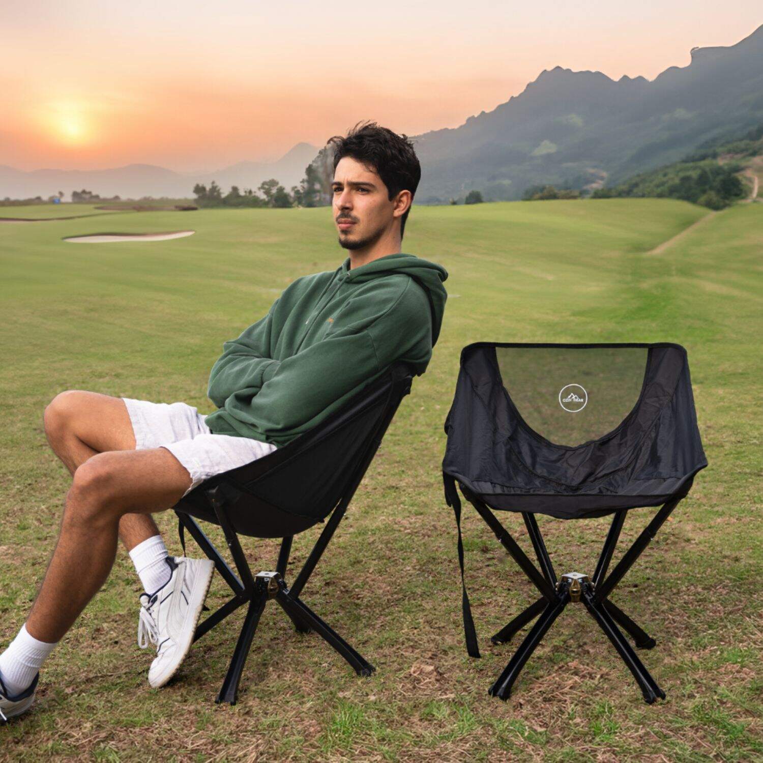 Man sitting on compact, foldable Ozzi Gear chair