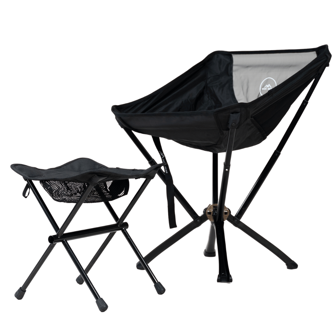 A black portable foot stool with metal frame and a fabric seat, designed for outdoor use.