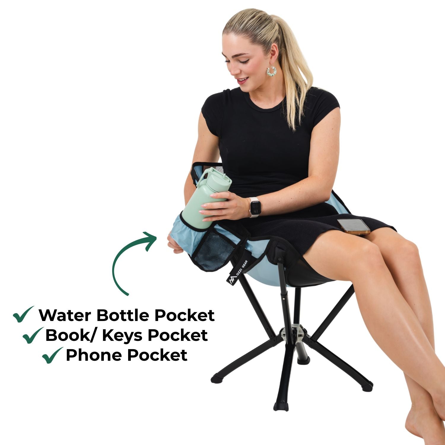 Woman sitting on a folding stool with multiple pockets, holding a water bottle.